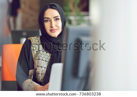 Muslim asian woman working in office with laptop
