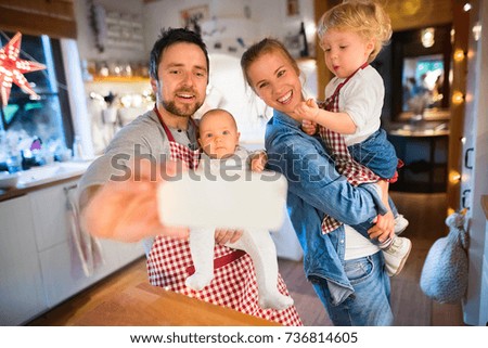 Young family making cookies at home.