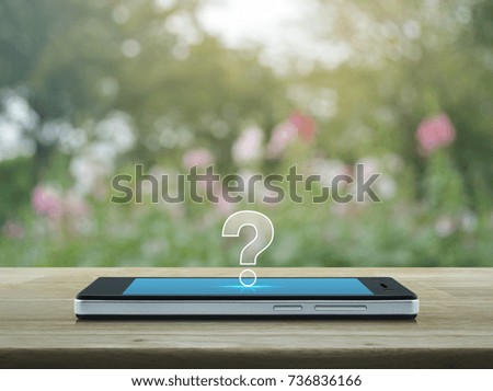 Question mark icon on modern smart phone screen on wooden table over blur pink flower and tree, Customer support concept