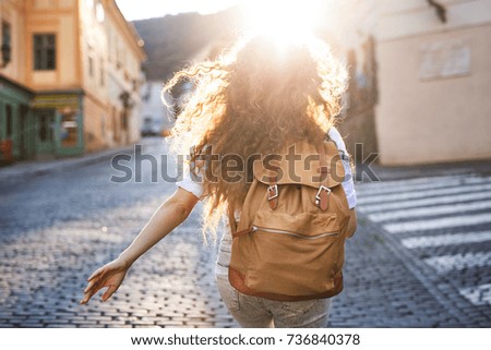 Young tourist with backpack in the old town.
