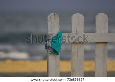 little white fence on the beach on sea background