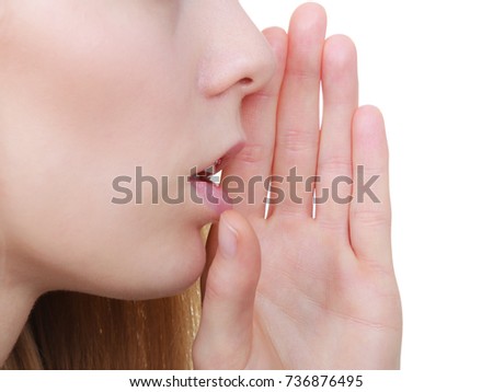 Gestures and signs concept. Young blonde woman whispering to somebody having open hand next to mouth.