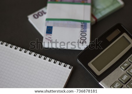 bundle of money calculator on a black background