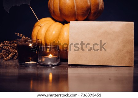 composition for decorating a house for halloween, yellow and orange pumpkins, burning scented candles