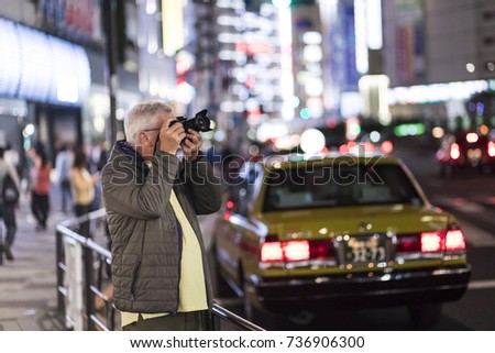 Tourist taking picture in Ikebukuro, Japan