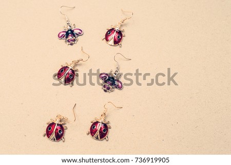 Ladybugs and bees earrings on Kraft paper