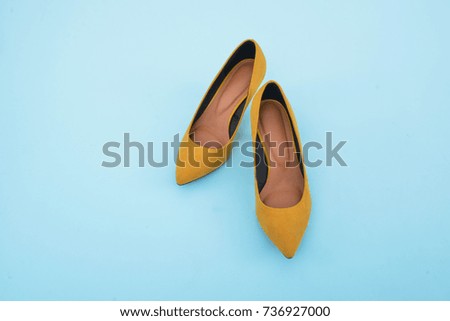 female yellow shoes- light blue background