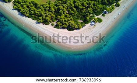 Aerial bird's eye photo taken by drone of exotic seascape and sandy beach with turquoise clear waters and pine trees, Rovies, North Evoia island, Greece