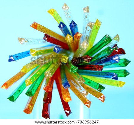 A stack of colorful glittery platic sticks abstract