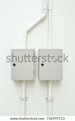 Electric control box on the white wall of factory.