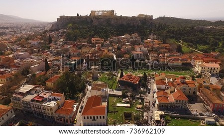 Aerial birds eye view photo taken by drone of iconic Acropolis hill as seen from Plaka district, Athens historic center, Attica, Greece