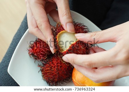 eating a refreshing piece of Rambutan fruit for a healthy snack