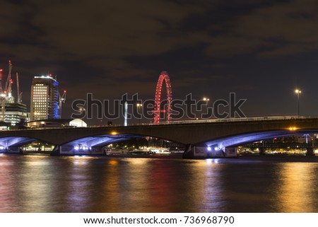 Waterloo bridge London. Beautiful photo of the city at night. Ferris wheel, bridges and buildings with lights. Nice reflections in river Thames. Lovely architectures in England.