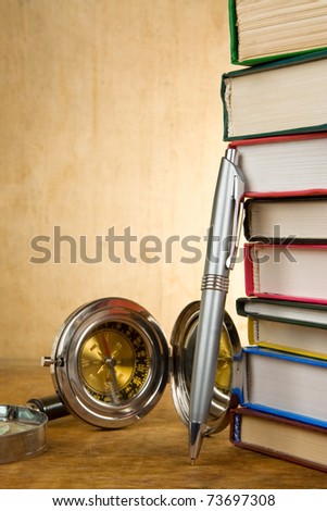 pile of books and pens on wood texture