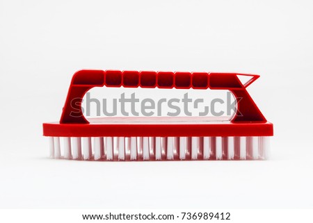 Red brush for cleaning shoes on a white background