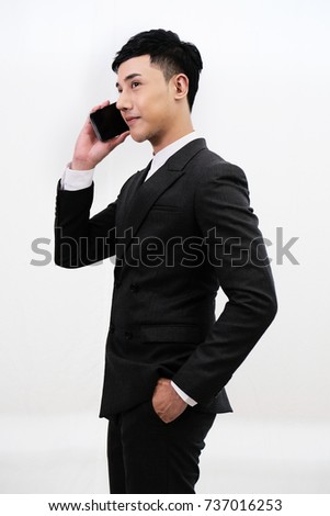 Portrait of a handsome business man, talking on mobile phone, isolated on white background