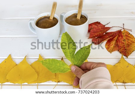 two cups of coffee and  autumn leaves.Autumn concept