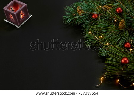 Christmas. Xmas toys and spruce branch on black background top view. Space for text