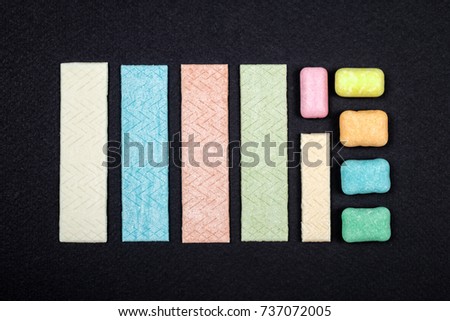 Top view of organized chewing gum on black background