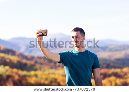 Young man taking a selfie in the park
