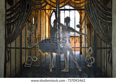 forged gate with a silhouette of people