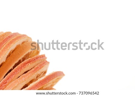Slices of dried orange in one corner on white background