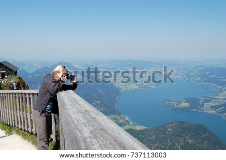 A young girl takes pictures nature, Austria, St. Wolfgang, mountain Schafbergbahn