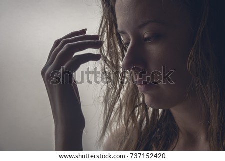The silhouette of stressed and depressed woman. sad girl near window thinking about something. Person side view,Sadness and thoughtful concept.