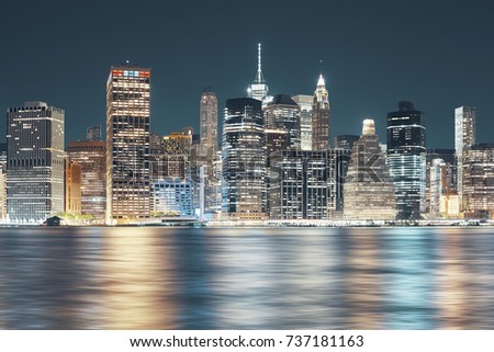 New York City skyline seen from Brooklyn at night, color toning applied, USA.