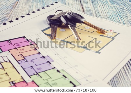 Linking new key on project plan of apartment house Concept new residence house warming Buying Selling Real Estate
