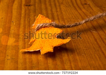 New Year Concept. Christmas decorations hand made from tangerine peel on wooden background