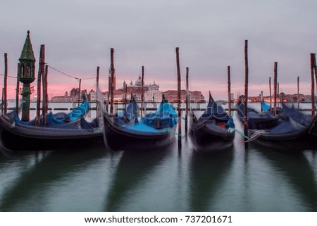 Gondolas moored by Saint Mark square with San Giorgio di Maggiore church on background
