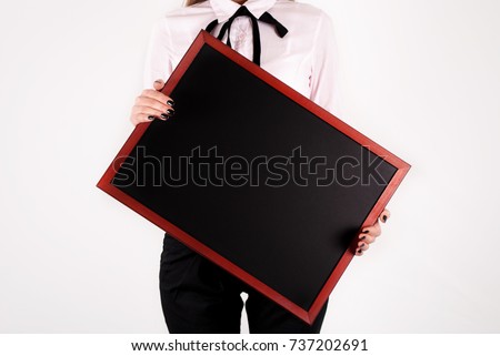 Woman holding blackboard in hands. Close up