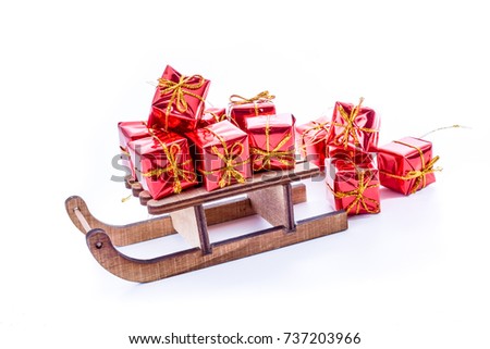 wooden sled toy with red xmas gifts. Christmas and New Year concept. Christmas greeting card.