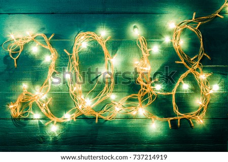 Photo of burning garland in form of number 2018 on blue table