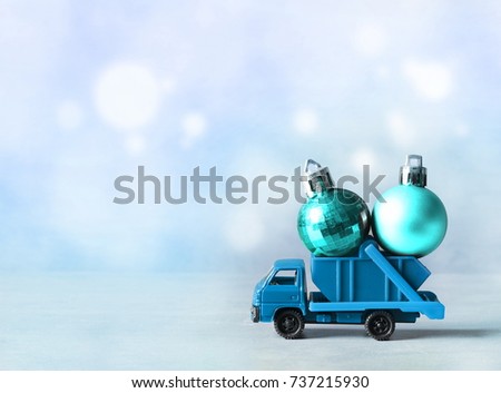 Christmas decoration. Truck car carries decorations for Christmas trees. Christmas ball.
