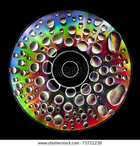 Compact Disc CD with water drops on the data surface with a shiny colorful reflection