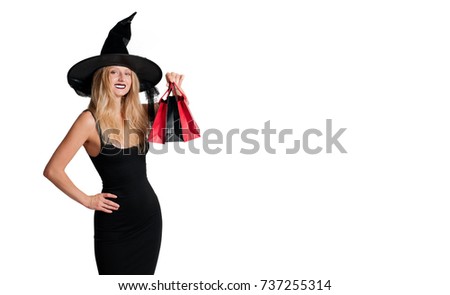 Halloween shopping. Happy woman in witch halloween costume with hat