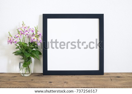 frame photo with violet flower in vase on table. Happy summer day or home decor