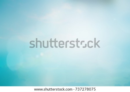 blurred peaceful natural blue sky clouds landscape background with glowing flare light
