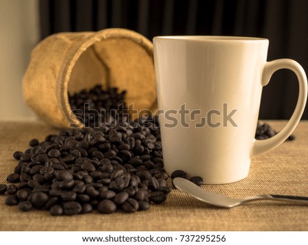 White cup with coffee bean and bag. 