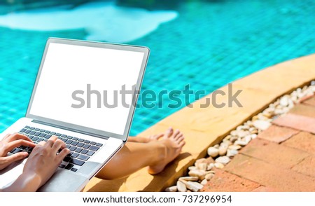 Woman bikini using laptop computer blank screen at swimming pool in resort edge, Close up hand