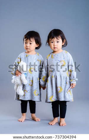 Cute twins children studio portrait