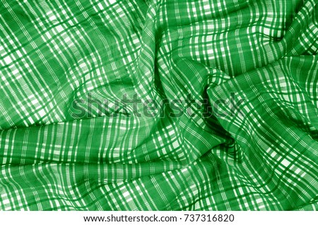 background texture. silk fabric checkered green white. beautiful silk taffeta-twill with wicker check in the "eternal bell" of green and orchid.