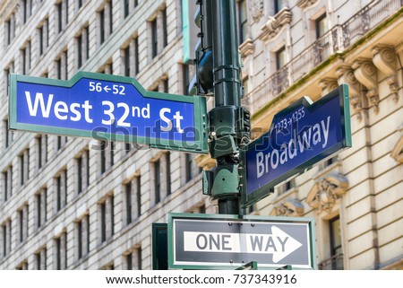West 32 amd Broadway signs along city streets, NYC.