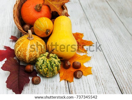 Pumpkin and autumn  leaves on a old wooden table