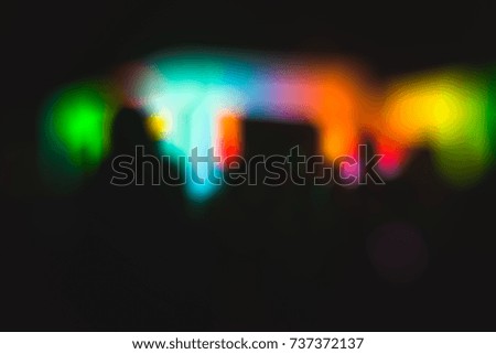 blurred multicolored gradient of light on a black background. with space for text at the bottom of the image.