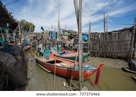 Thai small fishing boats have docked at fishing village at day time.