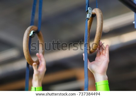 Young Male Athlete With Gymnastic Rings In The Gym.
