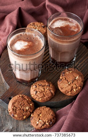 Cocoa drink in glass mug on  wooden rustic background